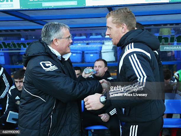 Micky Adams, manager of Tranmere greets Garry Monk, manager of Swansea City during the FA Cup Third Round match between Tranmere Rovers and Swansea...