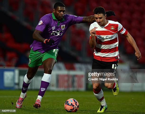 Enda Stevens of Doncaster Rovers challenged by Jay Emmanuel-Thomas of Bristol City during the FA Cup Third Round match between Doncaster Rovers and...