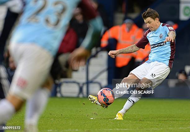 Gateshead's Welsh midfielder John Oster shoots wide from a free kick during the English FA Cup third round football match between West Bromwich...