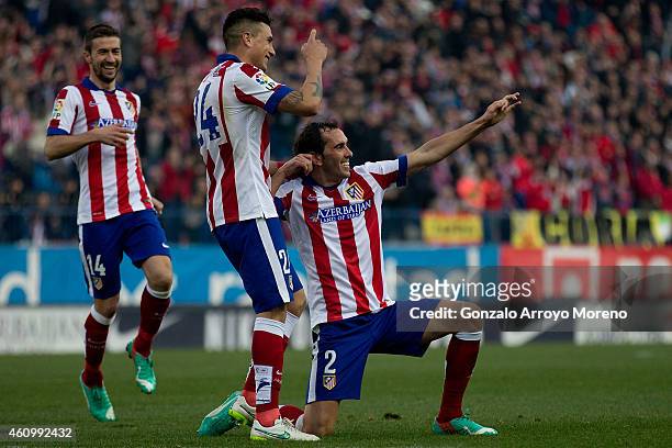 Diego Godin of Atletico de Madrid celebrates scoring their third goal with team-mates Jose Maria Gimenez and Gabi Fernandez during the La Liga match...