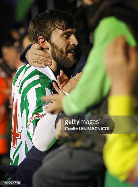 Blyth Spartans' English defender Danny Parker is hugged by fans in the crowd at full time in the English FA Cup third round football match between...