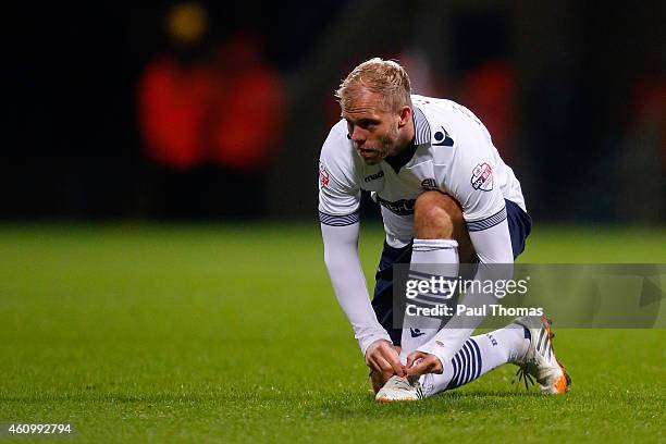 Eidur Gudjohnsen of Bolton ties his boot laces during the FA Cup Third Round match between Bolton Wanderers and Wigan Athletic at the Macron Stadium...