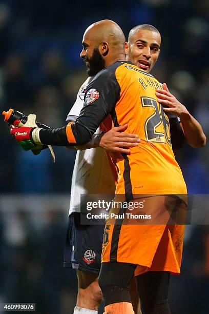 Darren Pratley of Bolton hugs Ali Al Habsi of Wigan at full time of the FA Cup Third Round match between Bolton Wanderers and Wigan Athletic at the...