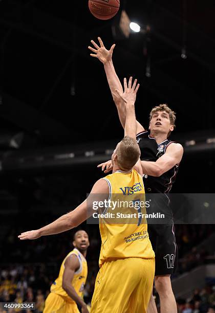 Kyle Visser of Braunschweig challenges Andreas Sieferth of Artland during the Bundesliga basketball game between Basketball Loewen Braunschweig and...