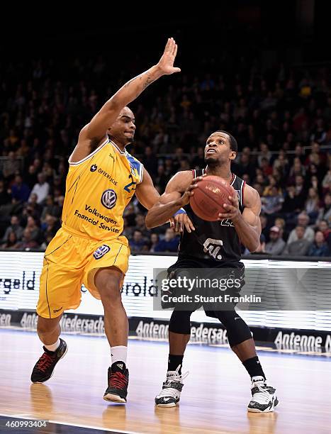 Immanuel McElroy of Braunschweig challenges Antonio Graves of Artland during the Bundesliga basketball game between Basketball Loewen Braunschweig...