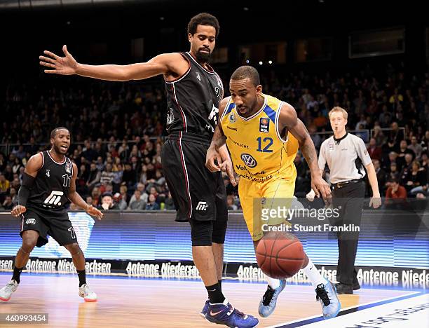 Dru Joyce of Braunschweig is challenged by Lawrence Hill of Artland during the Bundesliga basketball game between Basketball Loewen Braunschweig and...