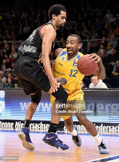 Dru Joyce of Braunschweig is challenged by Lawrence Hill of Artland during the Bundesliga basketball game between Basketball Loewen Braunschweig and...