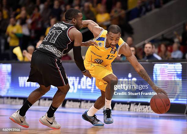 Dru Joyce of Braunschweig is challenged by David Holston of Artland during the Bundesliga basketball game between Basketball Loewen Braunschweig and...