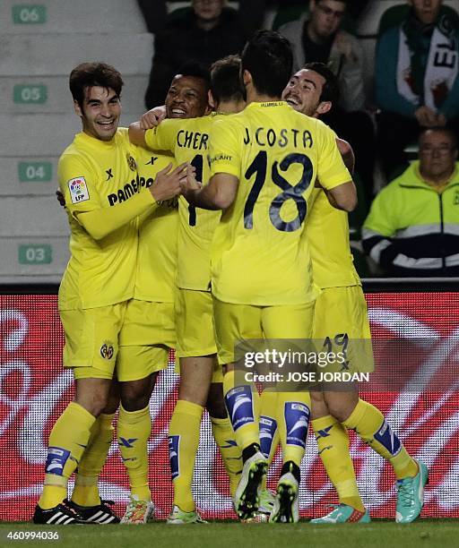 Villarreal's Nigerian forward Ikechukwu Uche celebrates his goal with teammates during the Spanish league football match Elche FC vs Villarreal CF at...