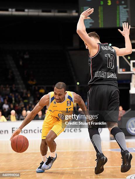 Dru Joyce of Braunschweig is challenged by Guido Gruenheid of Artland during the Bundesliga basketball game between Basketball Loewen Braunschweig...