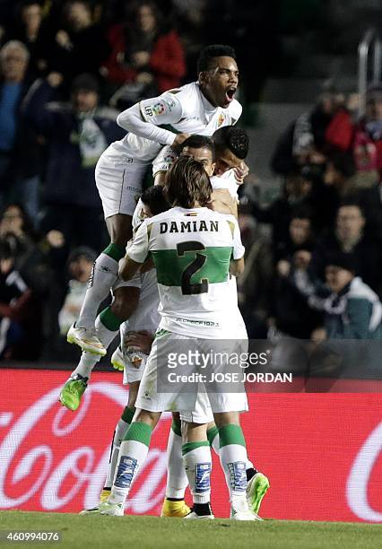 Elche players celebrate their second goal during the Spanish league football match Elche FC v Villarreal CF at the Martinez Valero stadium in Elche...