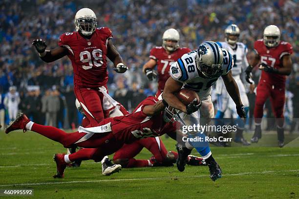 Jonathan Stewart of the Carolina Panthers breaks a tackle from Rashad Johnson of the Arizona Cardinals to score a touchdown during their NFC Wild...