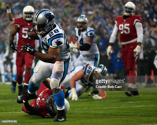 Jonathan Stewart of the Carolina Panthers breaks a tackle from Rashad Johnson of the Arizona Cardinals to score a touchdown during their NFC Wild...