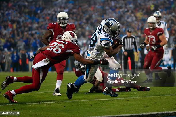 Jonathan Stewart of the Carolina Panthers breaks a tackle from Rashad Johnson of the Arizona Cardinals to score a touchdown during their NFC Wild...