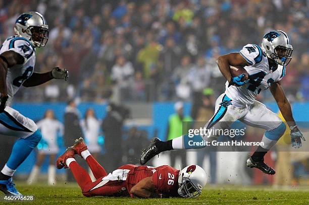 Fozzy Whittaker of the Carolina Panthers tries to avoid the tackle of Rashad Johnson of the Arizona Cardinals during their NFC Wild Card Playoff game...
