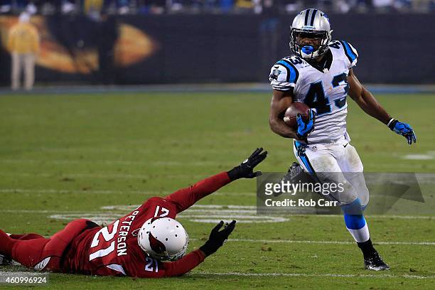 Fozzy Whittaker of the Carolina Panthers avoids a tackle from Patrick Peterson of the Arizona Cardinals during their NFC Wild Card Playoff game at...