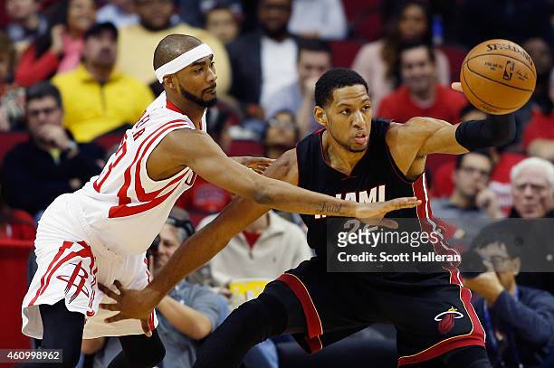 Danny Granger of the Miami Heat looks to pass the basketball as Corey Brewer of the Houston Rockets defends during their game at the Toyota Center on...