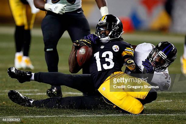 Dri Archer of the Pittsburgh Steelers is tackled by C.J. Mosley of the Baltimore Ravens during their AFC Wild Card game at Heinz Field on January 3,...