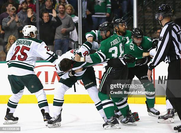 Vernon Fiddler of the Dallas Stars fights with Ryan Carter of the Minnesota Wild as Jason Demers of the Dallas Stars fights with Stu Bickel of the...