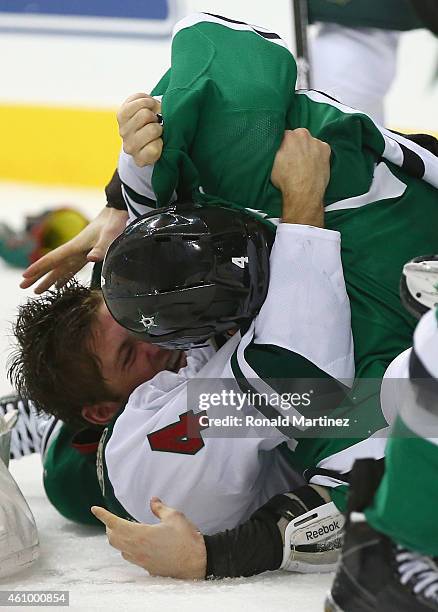 Stu Bickel of the Minnesota Wild fights with Jason Demers of the Dallas Stars in the second period at American Airlines Center on January 3, 2015 in...