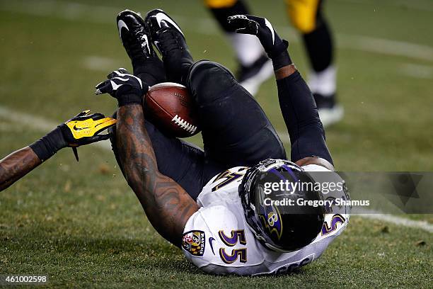 Terrell Suggs of the Baltimore Ravens catches an interception between his legs in the fourth quarter against the Pittsburgh Steelers during their AFC...