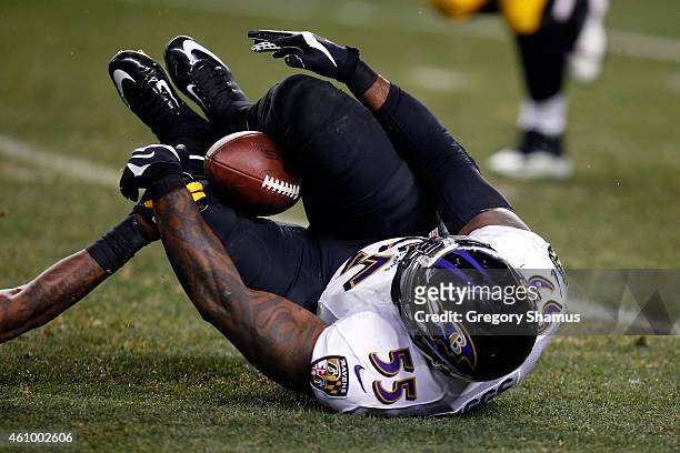 Terrell Suggs of the Baltimore Ravens catches an interception between his legs in the fourth quarter against the Pittsburgh Steelers during their AFC...