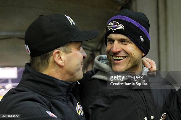 Michigan coach Jim Harbaugh celebrates with his brother, head coach John Harbaugh of the Baltimore Ravens after the Ravens defeated the Pittsburgh...