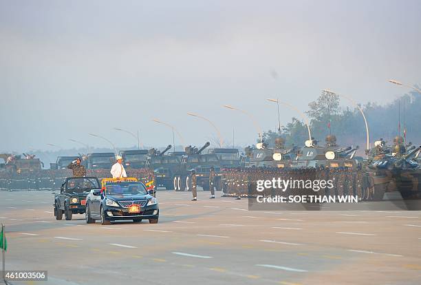 Myanmar President Thein Sein inspects troops during the 67th Myanmar Independence Day Grand Military Review parade in Naypyidaw on January 4, 2015....