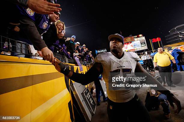 Terrell Suggs of the Baltimore Ravens celebrates with fans after defeating the Pittsburgh Steelers 30-17 in their AFC Wild Card game at Heinz Field...