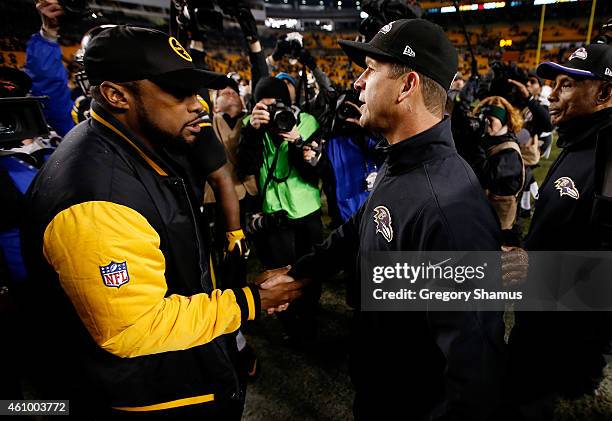 Head coach Mike Tomlin of the Pittsburgh Steelers meets head coach John Harbaugh of the Baltimore Ravens after the Ravens defeated the Steelers 30-17...