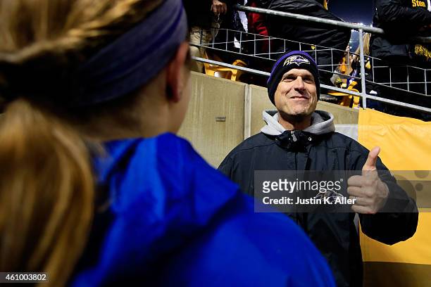 Michigan coach Jim Harbaugh celebrates after the Baltimore Ravens defeated the Pittsburgh Steelers 30-17 in their AFC Wild Card game at Heinz Field...