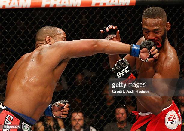Daniel Cormier punches Jon Jones in their UFC light heavyweight championship bout during the UFC 182 event at the MGM Grand Garden Arena on January...