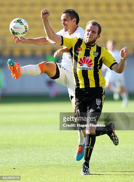 Jade North of the Roar and Jeremy Brockie of the Phoenix compete for the ball during the round 15 A-League match between the Wellington Phoenix and...