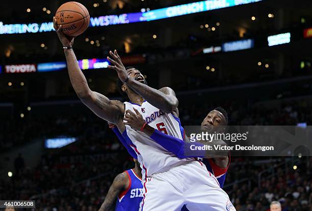 Robert Covington of the Philadelphia 76ers fouls DeAndre Jordan of the Los Angeles Clippers while Jordan is shooting in the second half during the...