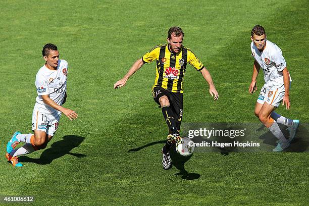 Jeremy Brockie of the Phoenix controls the ball under pressure from Jade North and Daniel Bowles of the Roar during the round 15 A-League match...