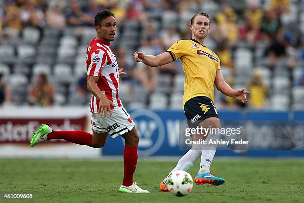 Zachary Anderson of the Mariners kicks the ball ahead of James Brown of Melbourne City during the round 15 A-League match between the Central Coast...