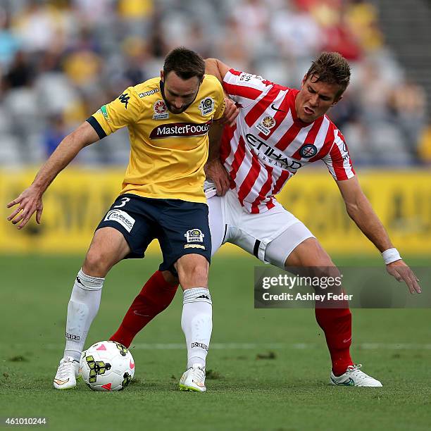 Joshua Rose of the Mariners contests the ball against Erik Paartalu of Melbourne City during the round 15 A-League match between the Central Coast...