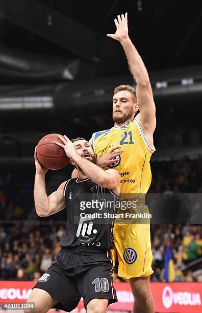 Tim Abromaitis of Braunschweig challenges Bastian Doreth of Artland during the Bundesliga basketball game between Basketball Loewen Braunschweig and...