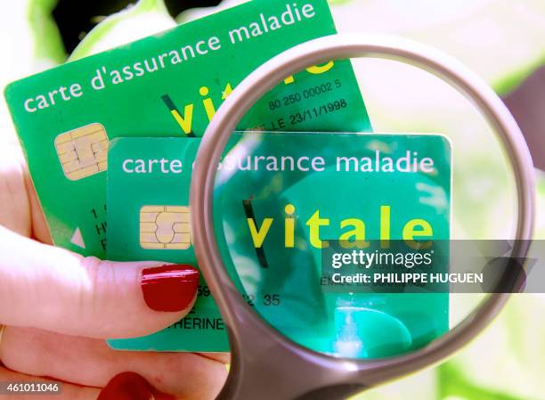 Picture taken on January 4, 2015 in Lille, northern France shows two "carte vitale" French social security affiliation cards. AFP PHOTO/PHILIPPE...