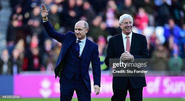 Members of the 1973 FA Cup winning side Dennis Tueart and Jimmy Montgomery wave to the crowd before before the FA Cup Third Round match between...