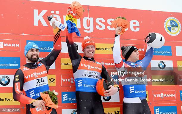 Andi Langhan of Germany, Felix Loch of Germany and Chris Mazdzer of the United States pose at the podium after the Men's FIL Luge World Cup...