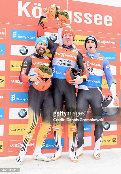 Andi Langhan of Germany, Felix Loch of Germany and Chris Mazdzer of the United States pose at the podium after the Men's FIL Luge World Cup...