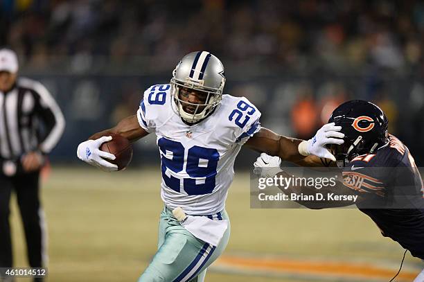 DeMarco Murray of the Dallas Cowboys stiff-arms Ryan Mundy of the Chicago Bears during the first quarter at Soldier Field on December 4, 2014 in...