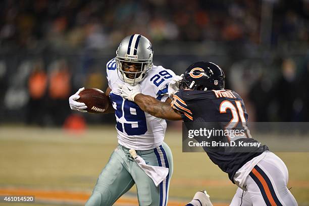 DeMarco Murray of the Dallas Cowboys stiff-arms Ryan Mundy of the Chicago Bears during the first quarter at Soldier Field on December 4, 2014 in...