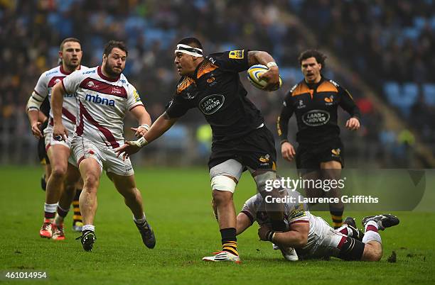 Nathan Hughes of Wasps is tackled by Vadim Cobilas of Sale during the Aviva Premiership match between Wasps and Sale Sharks at The Ricoh Arena on...