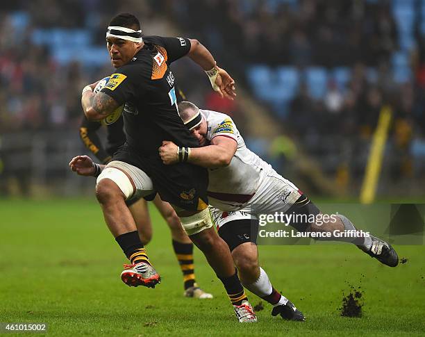 Nathan Hughes of Wasps is tackled by Vadim Cobilas of Sale during the Aviva Premiership match between Wasps and Sale Sharks at The Ricoh Arena on...