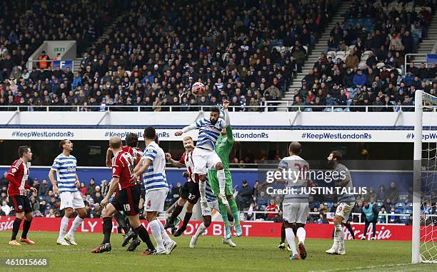 Queens Park Rangers' Senegalese defender Armand Traore leaps high to defend a corner during the English FA Cup third round football match between...