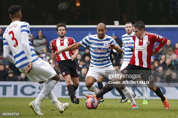 Sheffield United's Scottish striker Marc McNulty controls the ball in the box under pressure from Queens Park Rangers' English midfielder Karl Henry...