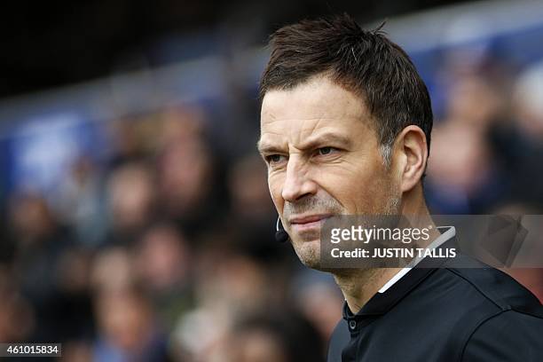 English referee Mark Clattenburg walks onto the pitch for the English FA Cup third round football match between Queens Park Rangers and Sheffield...