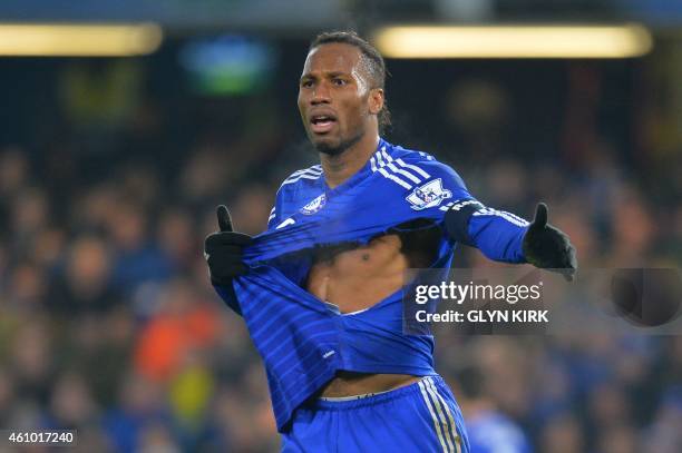 Chelsea's Ivorian striker Didier Drogba reacts as he walks on the pitch with a ripped shirt during the English FA Cup third round football match...